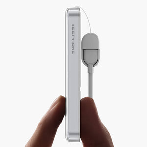 Hand holding sleek silver Icemag 5000mAh magnetic wireless power bank with attached cable, minimalist design.